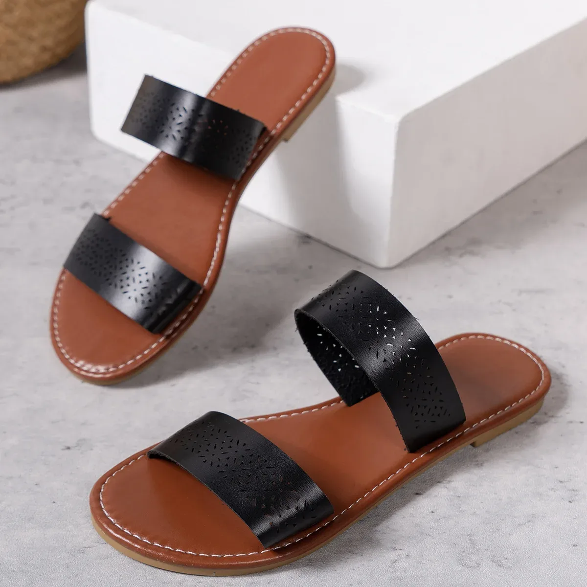 black flat slide sandals with wide double straps and cushioned footbed