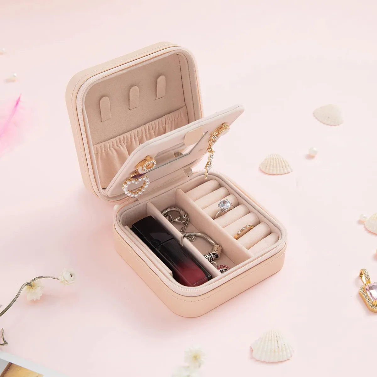 mini travel jewelry box with mirror holding rings, lipstick and earrings