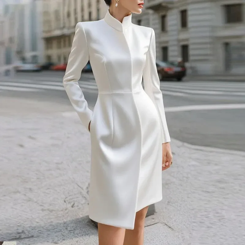 split hem of the white stand collar midi dress opening as the wearer walks