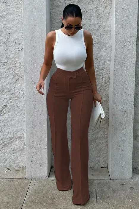 woman in brown straight leg dress pants and a white tank