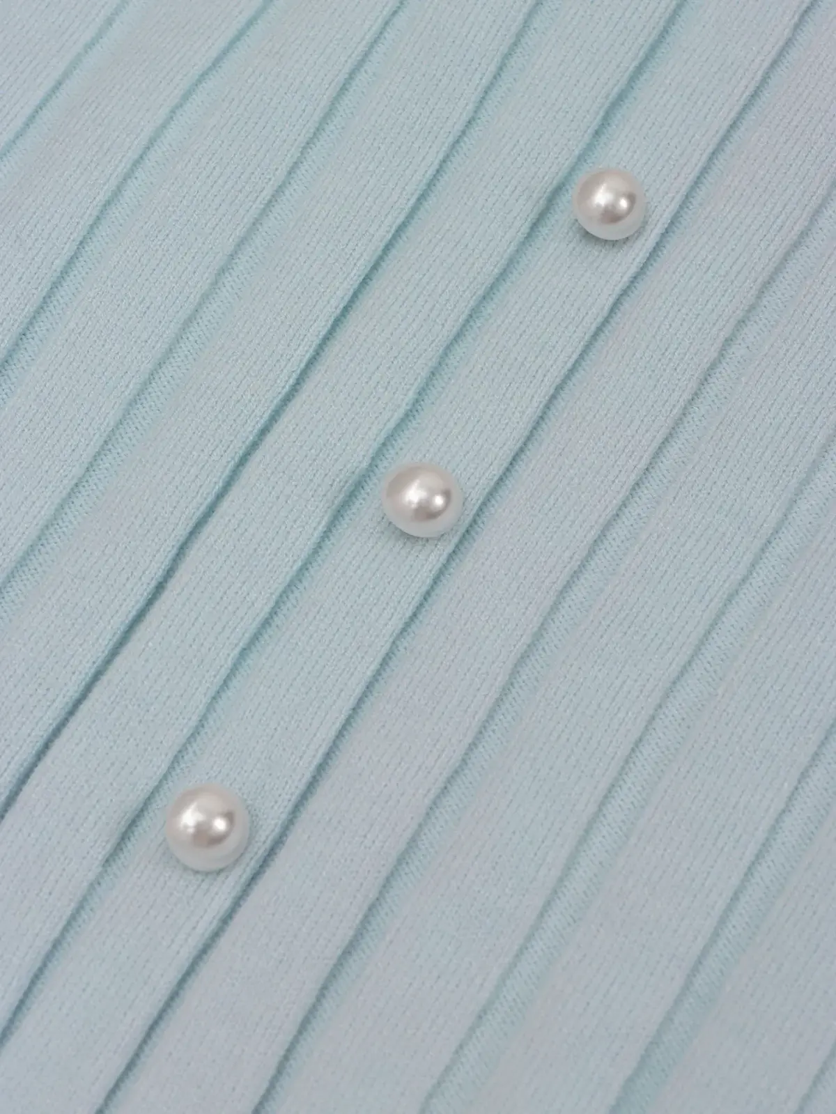 vertical rib knit texture of the midi dress with pearl buttons