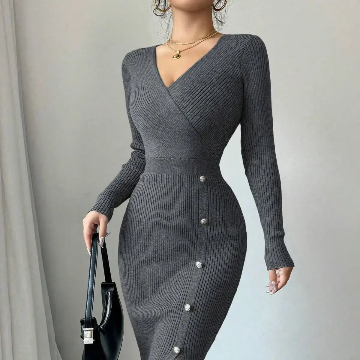 button trim running down the skirt of the dark grey knit midi dress