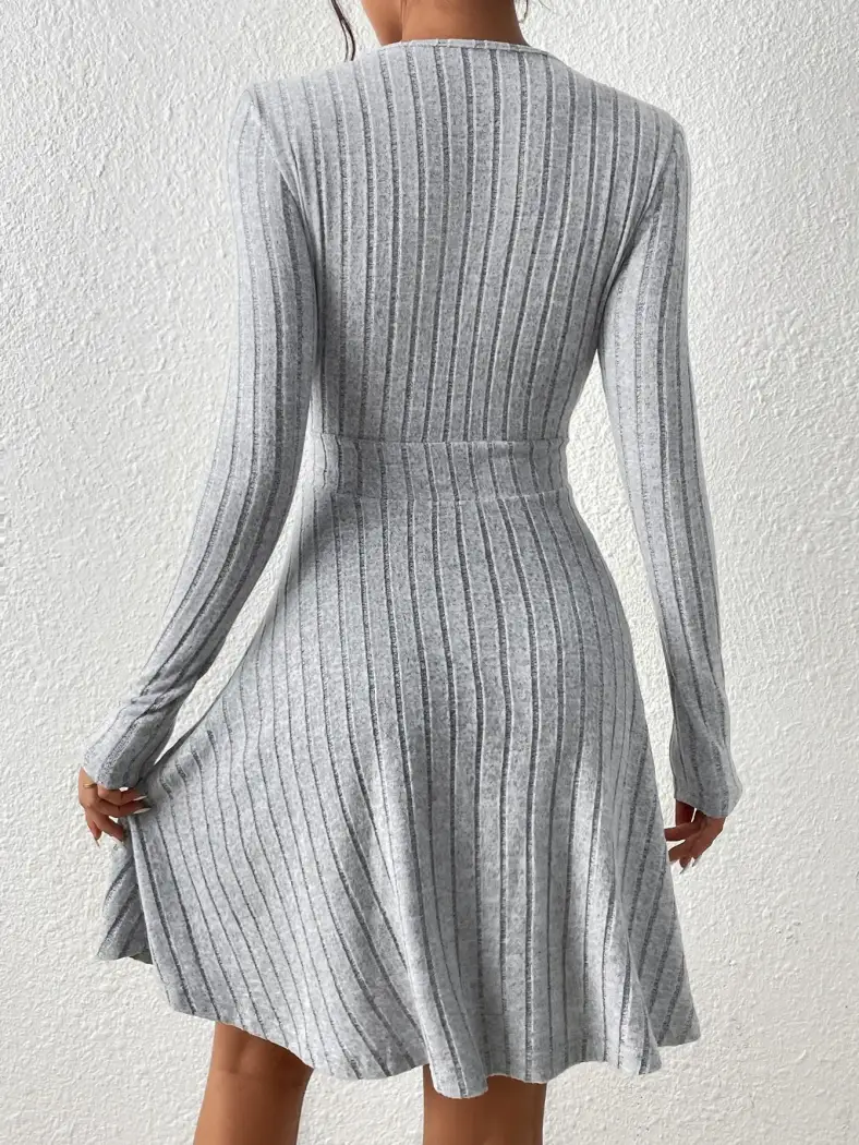 back view of the ribbed sweater dress with fitted waist and flared skirt