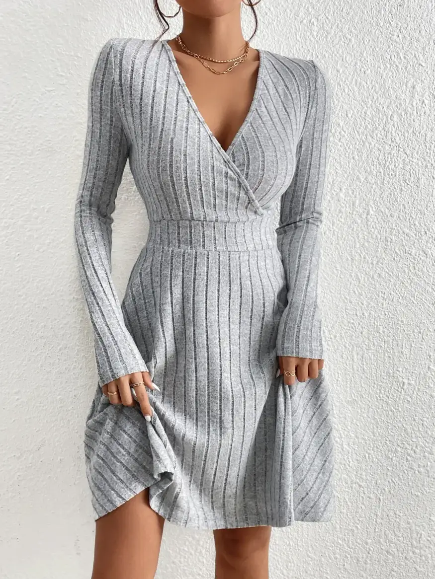 flared skirt of the ribbed sweater dress held out to show its swing