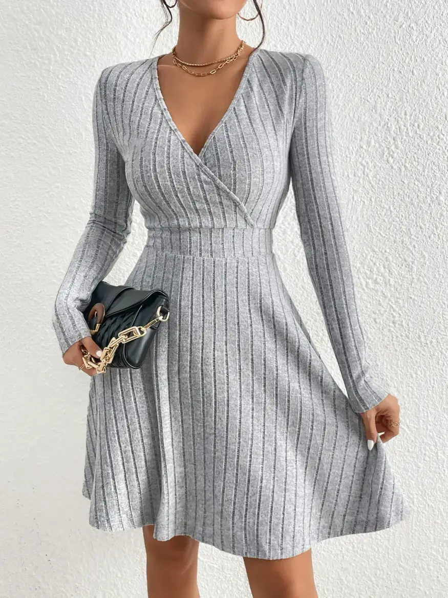 wrap neckline and waist seam of the grey ribbed sweater dress