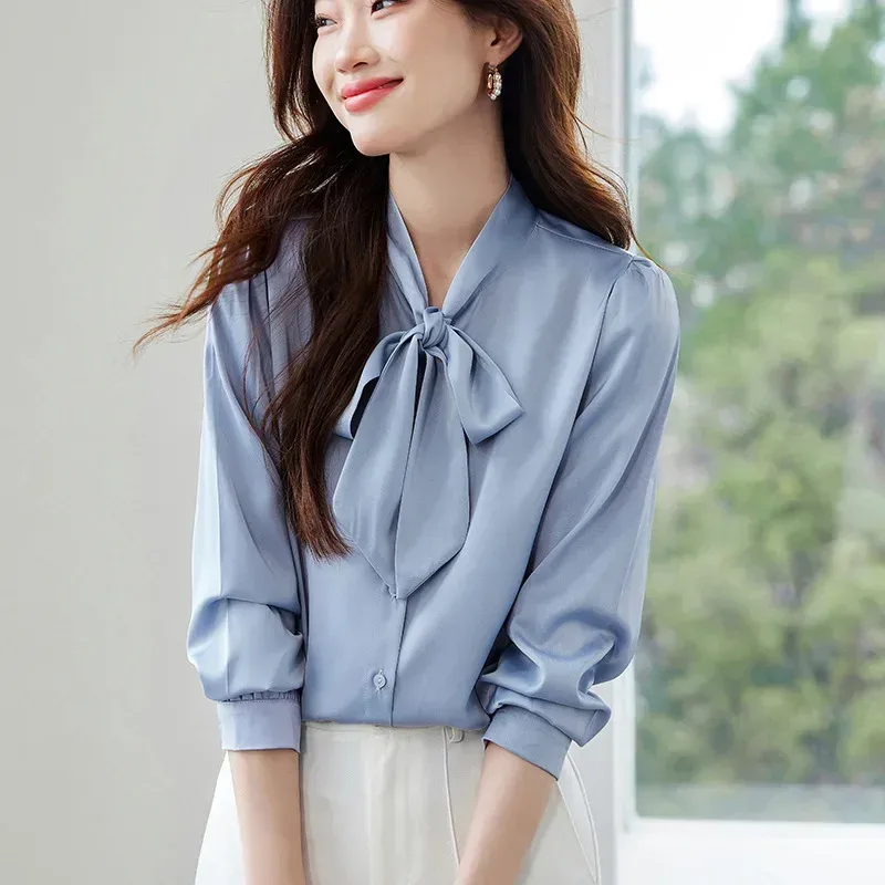satin tie neck blouse worn with the bow loosely tied