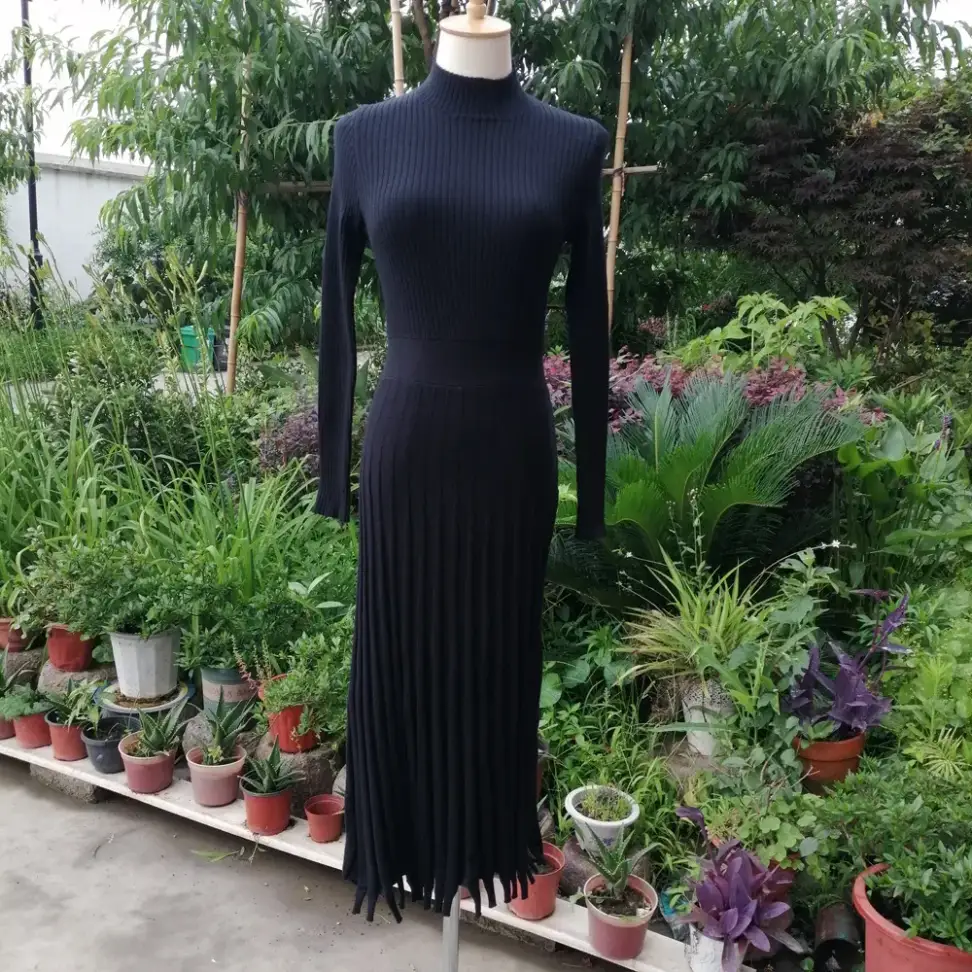 tabbed pleat hem on the black rib knit maxi sweater dress