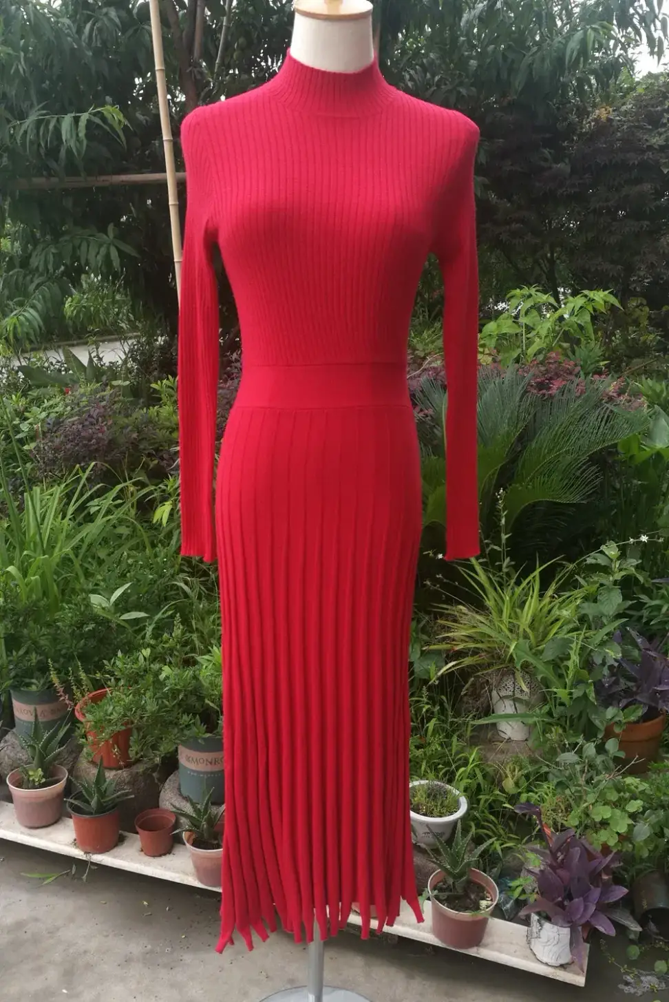 full length view of the red pleated rib knit maxi dress