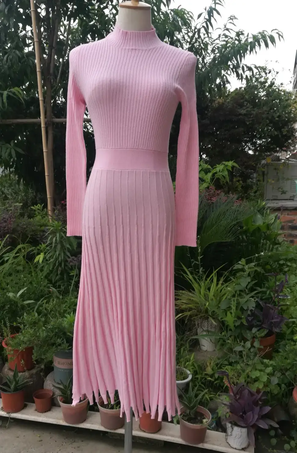 fitted rib knit bodice and wide waistband of the pleated maxi sweater dress