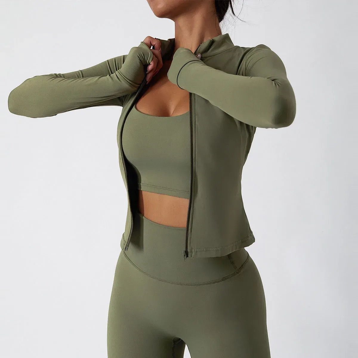 zip workout jacket worn open over the halter sports bra of the activewear set