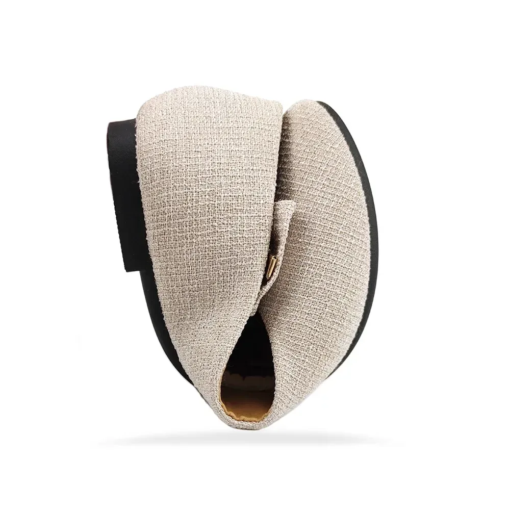 woven texture ballet flat bent in half to show its flexible sole