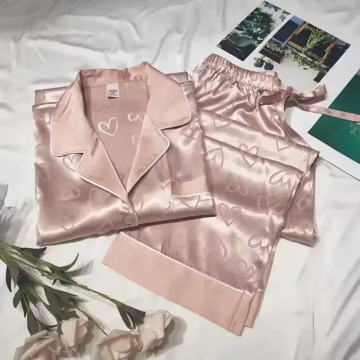 satin pajama pants with elastic waist and tie next to the matching shirt