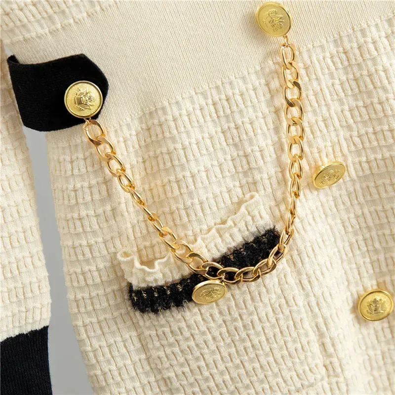 close up of the gold buttons, chain and trimmed pocket on the knit midi dress