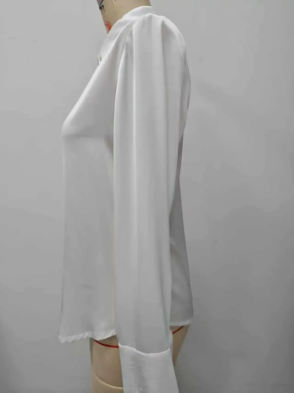 side view of the white long sleeve office shirt on a dress form