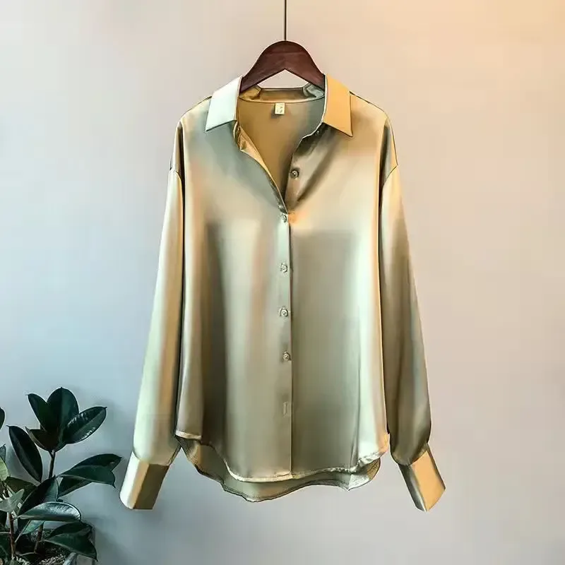 dropped shoulders and relaxed body of the green satin shirt