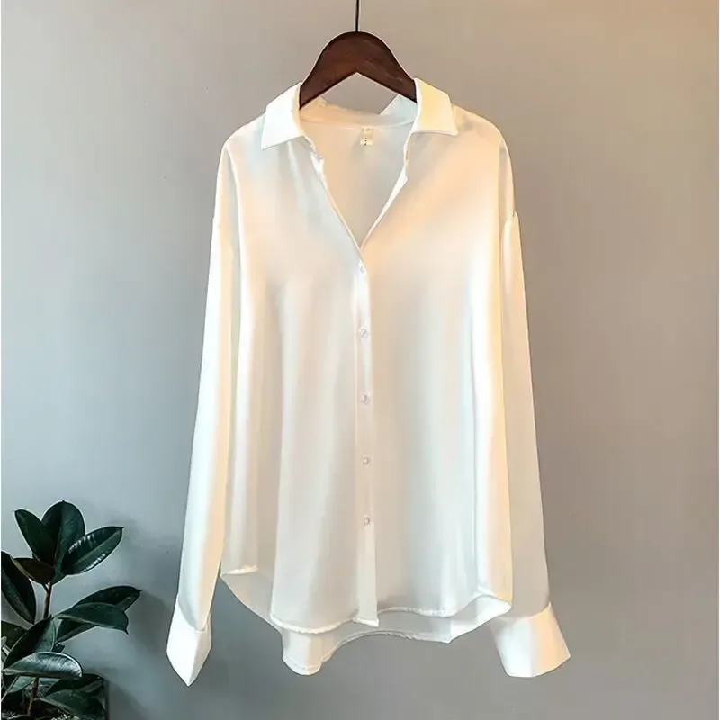 turn-down collar and button front of the white oversized satin shirt