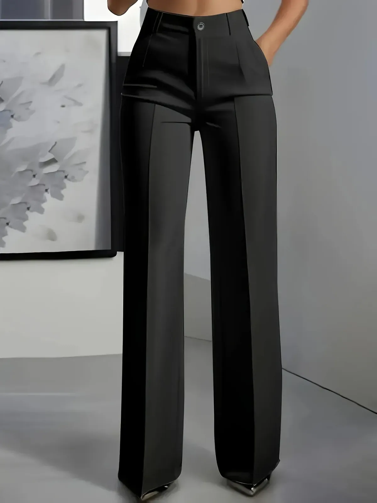 pressed front seam running down black wide leg trousers