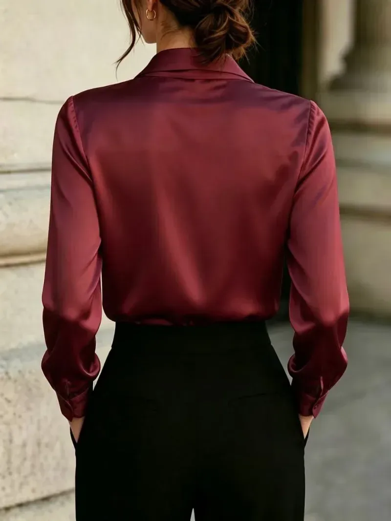 back view of the burgundy satin blouse tucked into black trousers