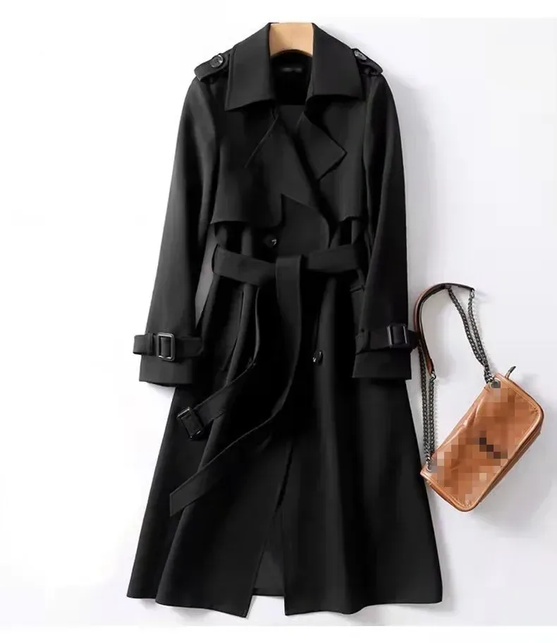 shoulder epaulettes and buckled cuff straps on the black trench coat