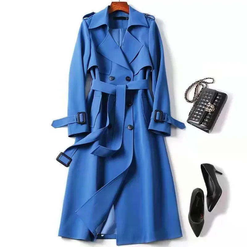 tie belt cinching the waist of the blue long trench coat