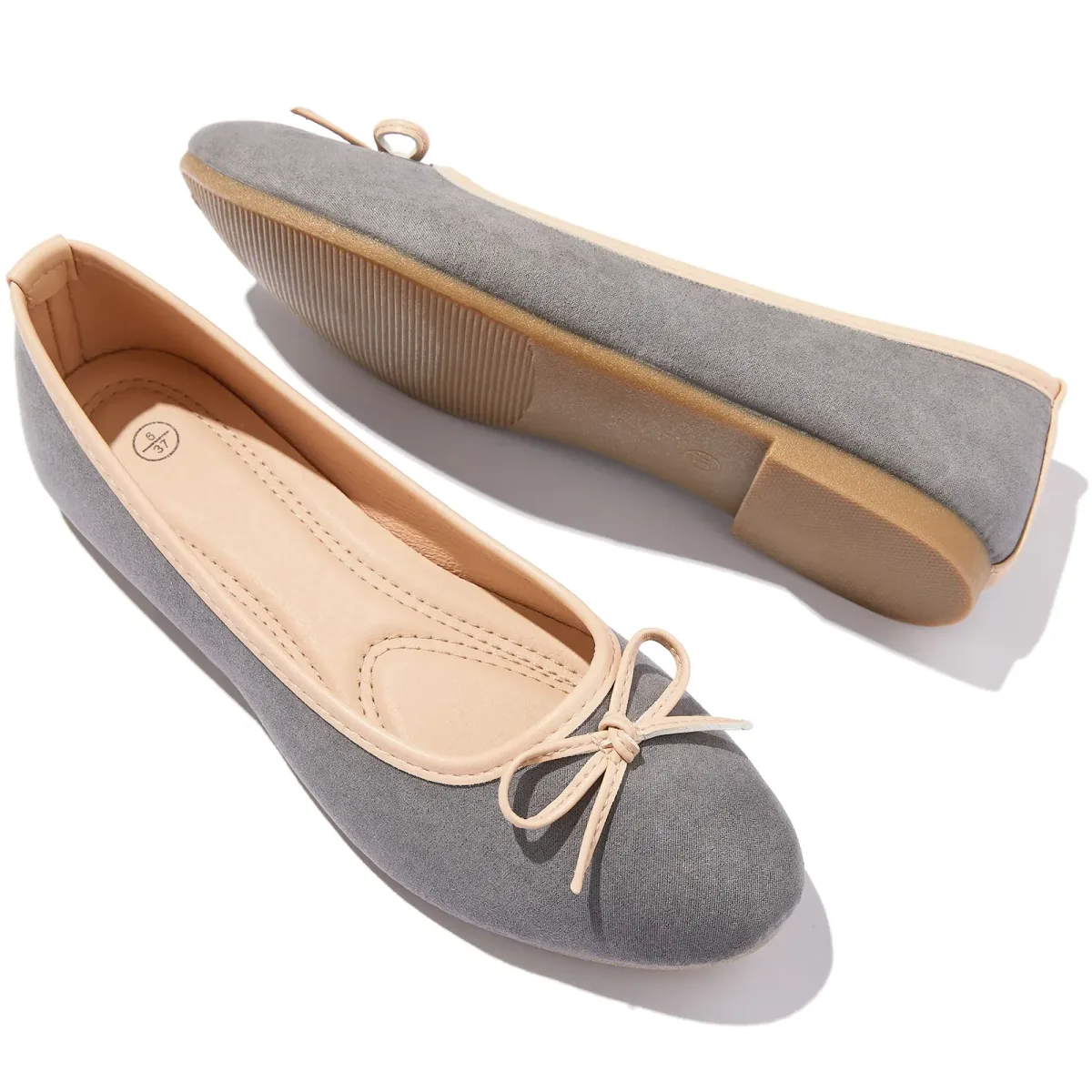 textured sole and low heel of a gray bow ballet flat