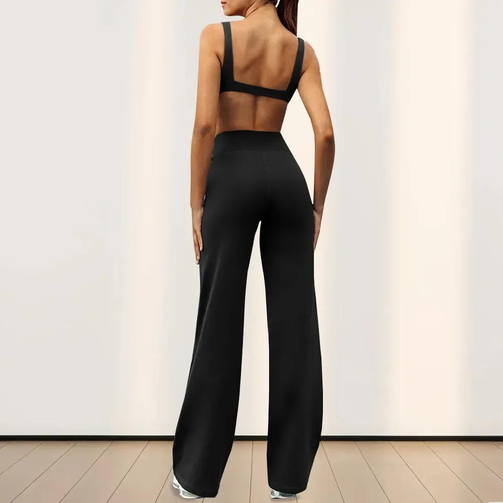 close fit of black high waist stretch pants through the hip, back view