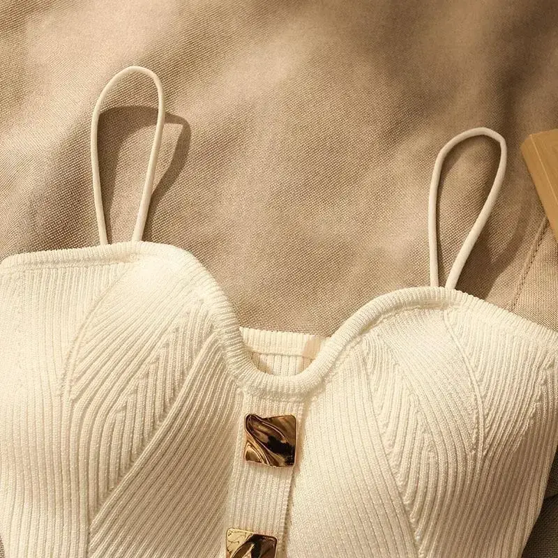 close up of the sweetheart neckline and hammered gold buttons on the knit cami top