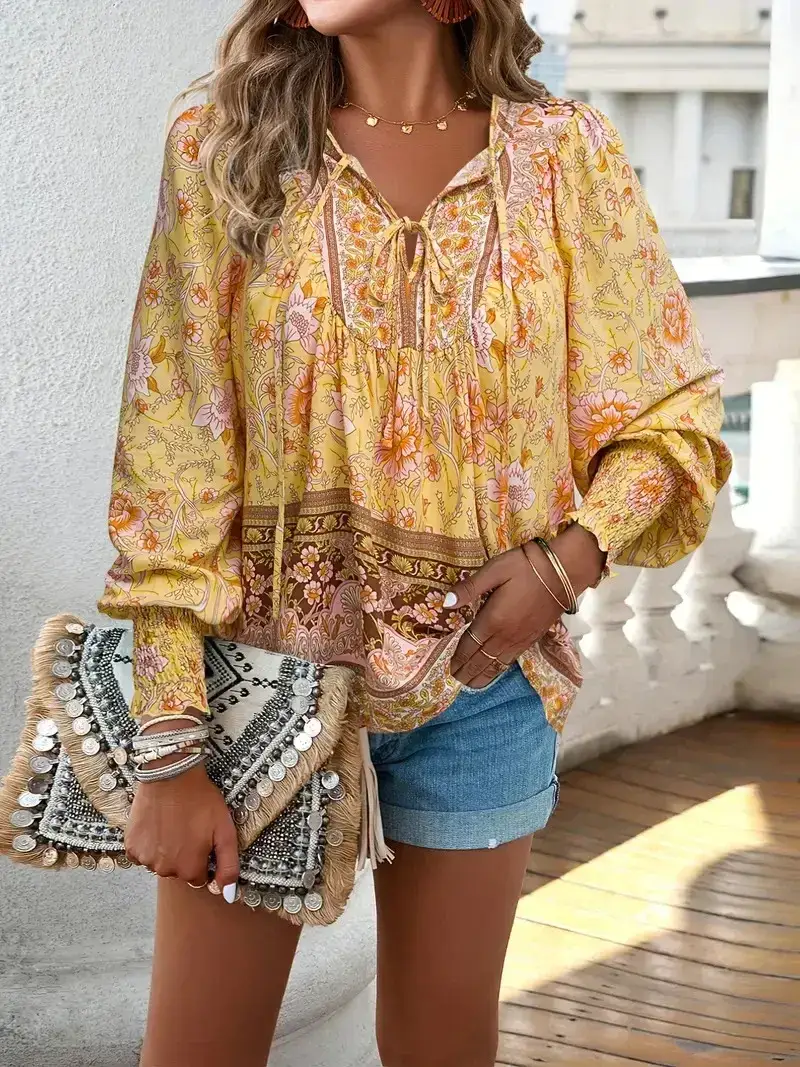 yellow boho floral print blouse with denim shorts on a terrace