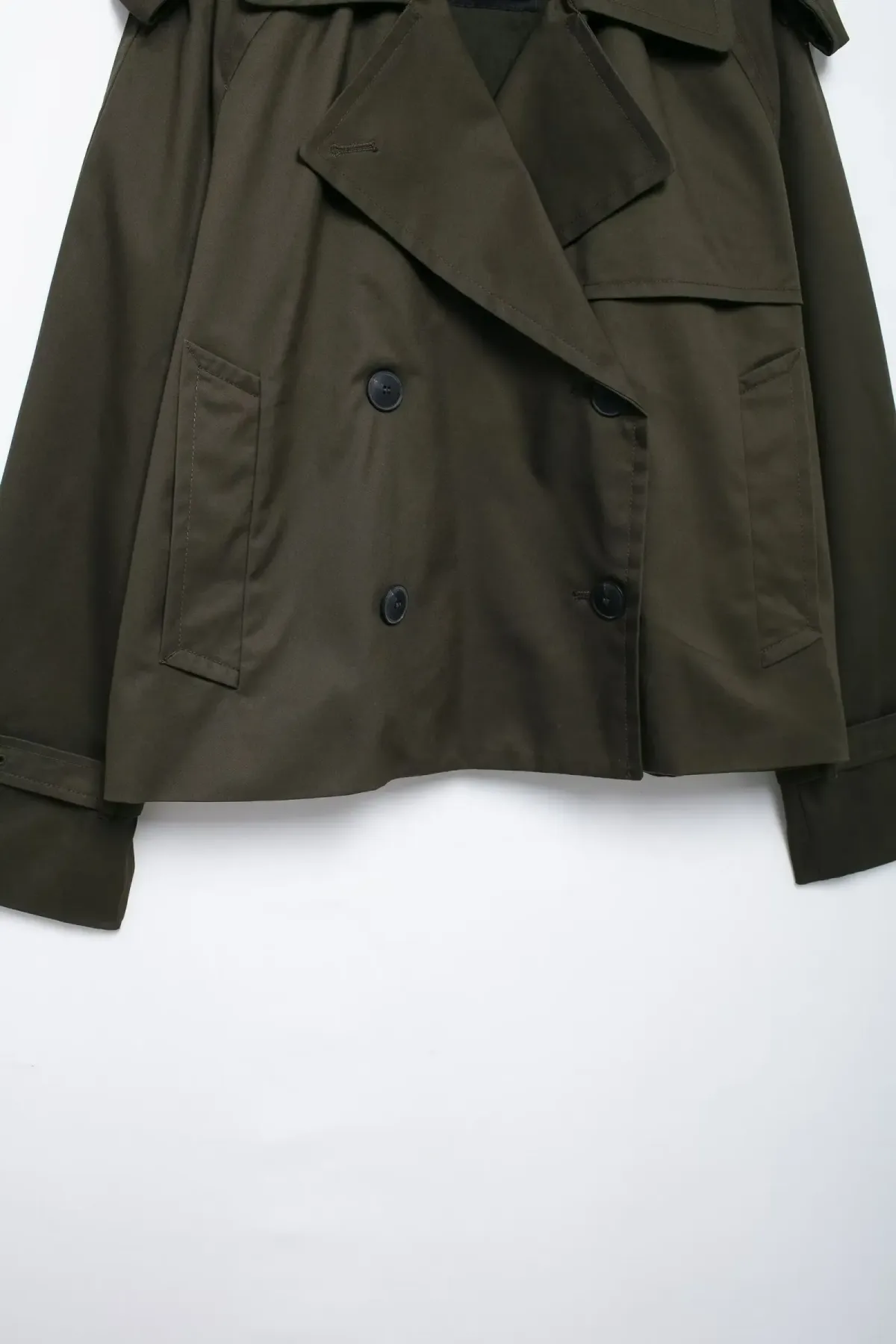 cropped hem and double breasted buttons of the trench jacket
