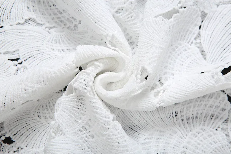 close view of the white floral and shell lace fabric
