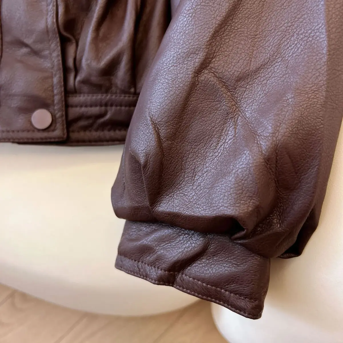 snap cuff on the sleeve of the faux leather jacket