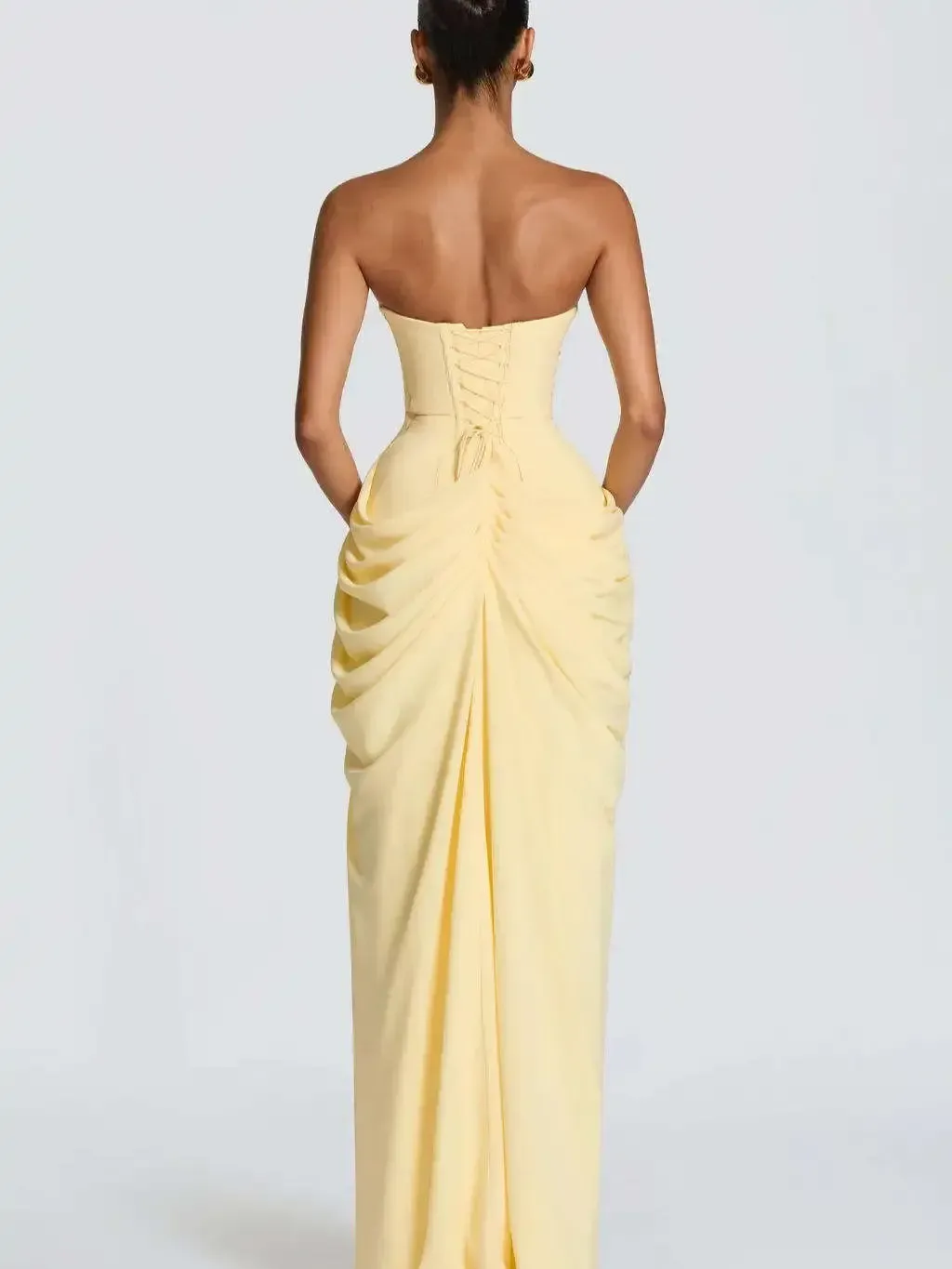 lace-up back of the light yellow strapless corset maxi dress