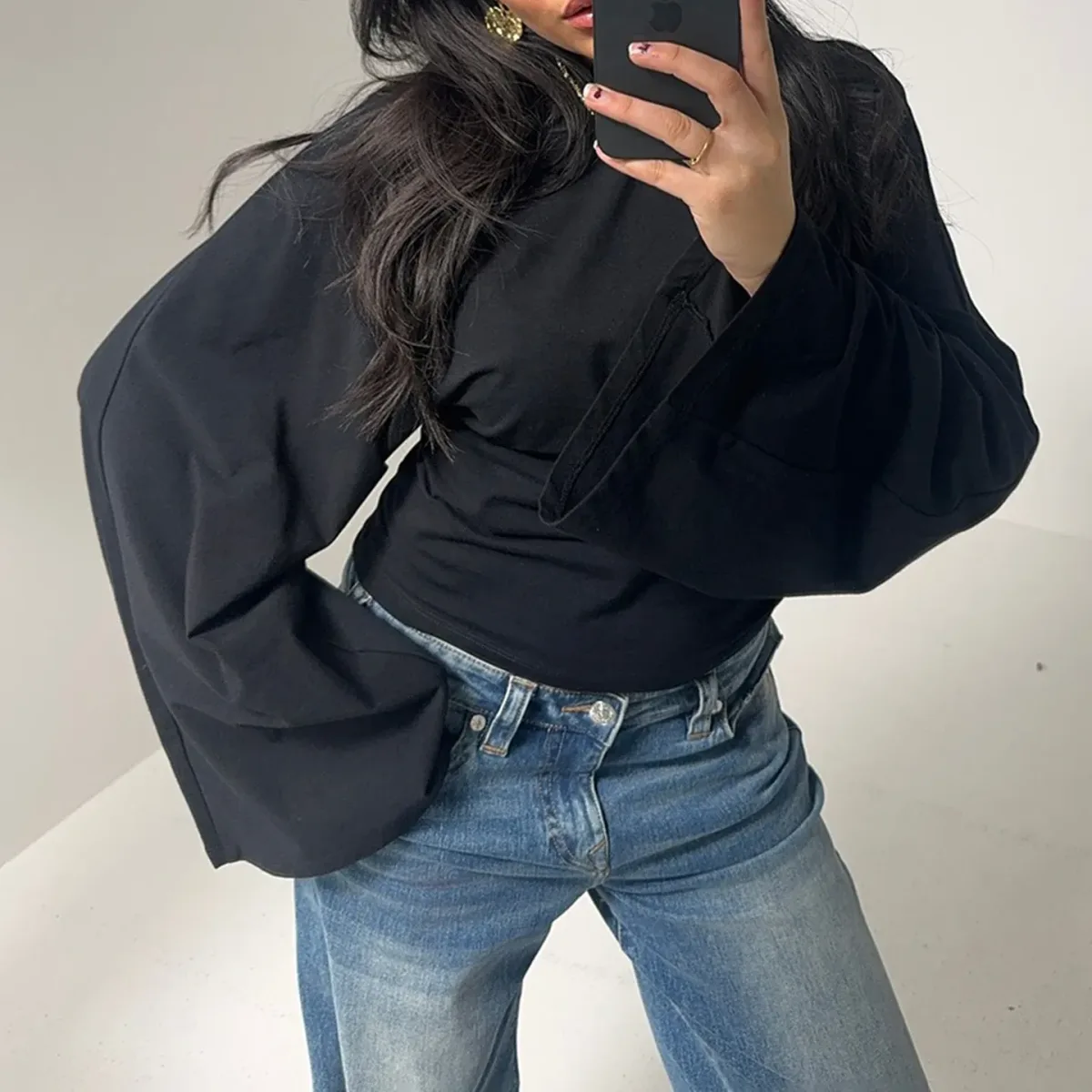 wide flared bell sleeves on the black knit crop top